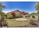Spacious backyard with green grass, patio, shed, and mature vegetation at 2727 S 160Th Ln, Goodyear, AZ 85338