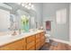 Bathroom featuring double sinks, wood-look flooring, and decorative accents at 2727 S 160Th Ln, Goodyear, AZ 85338