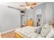 Bedroom with ceiling fan, wood flooring, and ensuite bathroom at 2727 S 160Th Ln, Goodyear, AZ 85338