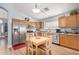 Eat-in kitchen features wood cabinets, stainless appliances, and wood-look flooring at 2727 S 160Th Ln, Goodyear, AZ 85338
