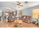 Comfortable living room with wood floors, ceiling fan, and two brown sofas at 2727 S 160Th Ln, Goodyear, AZ 85338