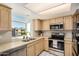 Well-lit kitchen featuring stainless steel appliances, generous counter space, and a bright window with neighborhood views at 2834 S Extension Rd # 2001, Mesa, AZ 85210