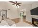 Bright living room featuring a fireplace, wood floors, and high ceilings connecting seamlessly to the dining area at 2834 S Extension Rd # 2001, Mesa, AZ 85210