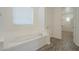 Relaxing bathroom with a soaking tub and wood-look flooring at 28917 N 66Th Ave, Phoenix, AZ 85083