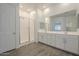 Bathroom featuring a glass-enclosed shower, dual sink vanity, and modern fixtures at 28917 N 66Th Ave, Phoenix, AZ 85083