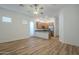 Open-concept kitchen and living area with stainless steel appliances and a breakfast bar at 28917 N 66Th Ave, Phoenix, AZ 85083