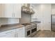 Close-up of the kitchen featuring stainless steel appliances and a gas range with a stainless steel hood at 28917 N 66Th Ave, Phoenix, AZ 85083