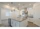 Bright kitchen featuring a center island with a beverage fridge, stainless steel appliances, and pendant lights at 28917 N 66Th Ave, Phoenix, AZ 85083