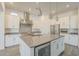 Modern kitchen with white cabinetry, stainless steel appliances, a center island, and pendant lighting at 28917 N 66Th Ave, Phoenix, AZ 85083
