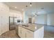 Well-equipped kitchen with a stainless steel refrigerator, center island, and views into the living room at 28917 N 66Th Ave, Phoenix, AZ 85083