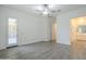 Spacious living room with neutral walls, gray wood-look flooring, and ample natural light at 28917 N 66Th Ave, Phoenix, AZ 85083