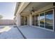 Covered patio featuring a ceiling fan, concrete flooring, and sliding glass doors at 28917 N 66Th Ave, Phoenix, AZ 85083