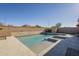 Backyard pool with a spa, desert landscaping, and privacy wall at 28917 N 66Th Ave, Phoenix, AZ 85083
