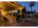 Inviting backyard with covered patio, string lights, built-in planters, and outdoor grill at 300 E Moore Ave, Gilbert, AZ 85234