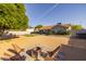 Charming backyard features a firepit, lounge chairs, and an artificial turf area for outdoor games at 300 E Moore Ave, Gilbert, AZ 85234