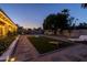 Beautiful backyard featuring cornhole, lounge chairs, pavers, and lush landscaping at 300 E Moore Ave, Gilbert, AZ 85234