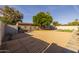 Expansive backyard showcasing desert landscaping, a fire pit seating area, and ample space for recreation and outdoor gatherings at 300 E Moore Ave, Gilbert, AZ 85234