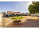 Spacious backyard features turf area with cornhole, lounge chairs, patio and updated landscaping at 300 E Moore Ave, Gilbert, AZ 85234