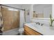 Bright bathroom featuring stylish vanity, shower with tan tile, and modern fixtures at 300 E Moore Ave, Gilbert, AZ 85234