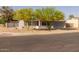 Corner lot home with desert landscaping and mature trees, offering curb appeal and natural beauty at 300 E Moore Ave, Gilbert, AZ 85234