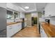 Modern kitchen featuring stainless steel appliances, wood countertops, and bright white cabinets at 300 E Moore Ave, Gilbert, AZ 85234