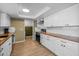 Well-lit kitchen with white cabinets, stainless steel appliances, and wood countertops at 300 E Moore Ave, Gilbert, AZ 85234