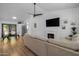 Bright living room with hardwood floors, a ceiling fan, and a cozy fireplace, perfect for relaxation and entertaining at 300 E Moore Ave, Gilbert, AZ 85234