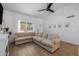 Spacious living room featuring a large window with natural light and comfortable seating, creating an inviting atmosphere at 300 E Moore Ave, Gilbert, AZ 85234