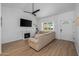 Open-concept living room with a fireplace and hardwood floors, ideal for Gathering gatherings and cozy evenings at 300 E Moore Ave, Gilbert, AZ 85234