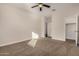 Bright bedroom featuring neutral paint, plush carpeting, and a ceiling fan for comfort at 30003 W Rockmount Ave, Buckeye, AZ 85396