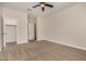 Bright bedroom with plush carpet, ceiling fan, walk in closet and neutral paint at 30003 W Rockmount Ave, Buckeye, AZ 85396