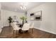 Bright dining room boasting a modern chandelier, stylish decor, and neutral tones at 30003 W Rockmount Ave, Buckeye, AZ 85396