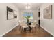 Formal dining room featuring a round table, modern chairs, and stylish art at 30003 W Rockmount Ave, Buckeye, AZ 85396