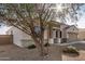 Single-story home with desert landscaping in the front and a two-car garage in a warm neighborhood at 30003 W Rockmount Ave, Buckeye, AZ 85396