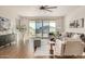 Bright living room featuring modern furniture, wood floors, and sliding glass doors at 30003 W Rockmount Ave, Buckeye, AZ 85396