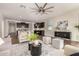 Open-concept living room showcasing wood floors, a decorative rug, and views into the kitchen at 30003 W Rockmount Ave, Buckeye, AZ 85396