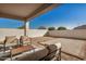 Back patio with seating and neutral patio pavers at 30003 W Rockmount Ave, Buckeye, AZ 85396