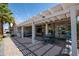 Attractive backyard showcasing a large covered patio and lush landscaping under a clear blue sky at 3070 N 148Th Dr, Goodyear, AZ 85395