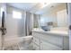 Bathroom with a white vanity, shower-tub combo, and a gray accent rug at 3070 N 148Th Dr, Goodyear, AZ 85395