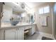 Bathroom boasts dual vessel sinks, white cabinetry, and modern fixtures at 3070 N 148Th Dr, Goodyear, AZ 85395