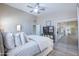Bedroom with light-colored walls, ceiling fan, sliding doors to patio, and wood-look flooring at 3070 N 148Th Dr, Goodyear, AZ 85395