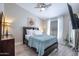 Cozy bedroom boasts a ceiling fan, natural light, and wood-look flooring at 3070 N 148Th Dr, Goodyear, AZ 85395