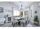 Bright dining room with a modern chandelier, white cabinets and view of the exterior patio at 3070 N 148Th Dr, Goodyear, AZ 85395