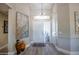 Welcoming foyer featuring high ceilings, stylish light fixtures, and modern decor creating a warm ambiance at 3070 N 148Th Dr, Goodyear, AZ 85395