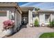 Inviting front entrance with beautiful landscaping, a brick walkway, and a secure gate at 3070 N 148Th Dr, Goodyear, AZ 85395