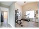 Home gym featuring exercise equipment, neutral walls, wood look floors, and natural light at 3070 N 148Th Dr, Goodyear, AZ 85395