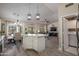 Open kitchen overlooking a dining and living area with white cabinets and quartz countertops at 3070 N 148Th Dr, Goodyear, AZ 85395