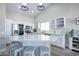 Bright kitchen with stainless steel appliances, white cabinets, and a quartz countertop island with stool seating at 3070 N 148Th Dr, Goodyear, AZ 85395