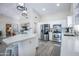 Modern kitchen with stainless steel appliances, white cabinetry, quartz countertops, and an eat-in kitchen island at 3070 N 148Th Dr, Goodyear, AZ 85395