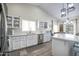 Bright kitchen featuring white cabinets, quartz countertops, stainless steel appliances, and a large island at 3070 N 148Th Dr, Goodyear, AZ 85395